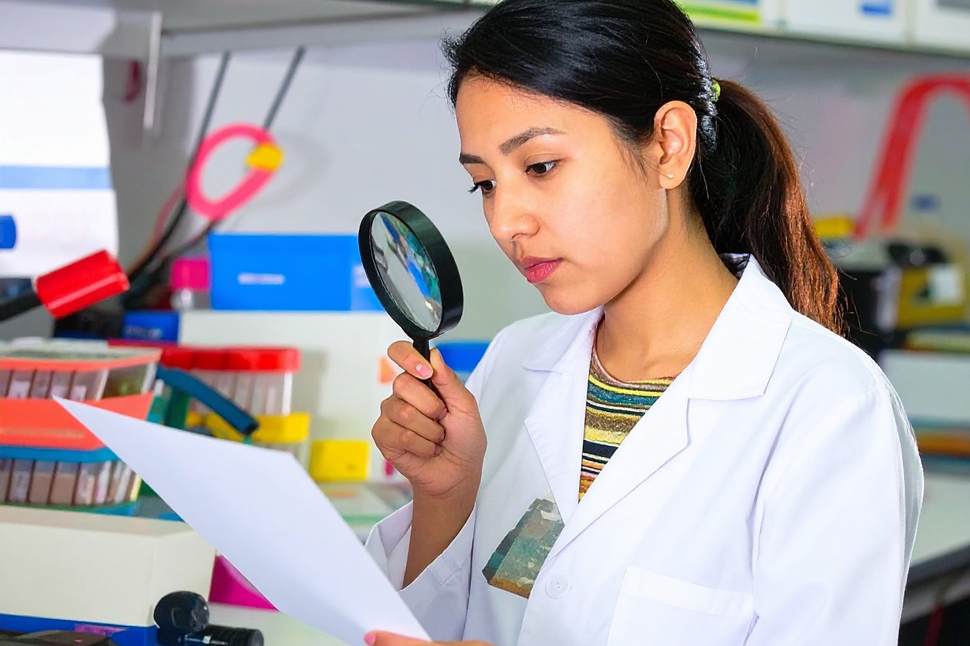 A printed sheet being checked under magnification in the quality lab